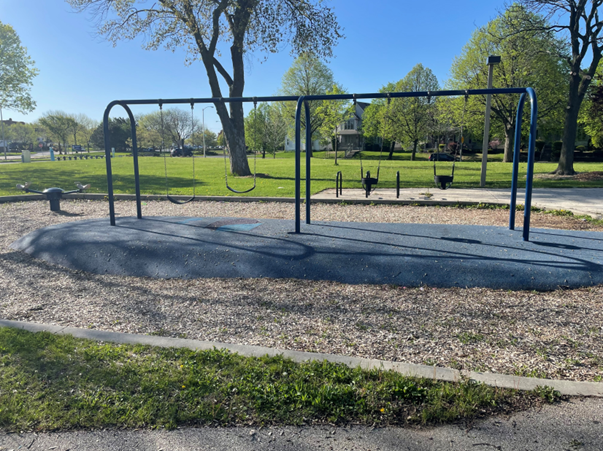 Commercial 2-bay swing set with bucket seats and belt swings for parks, featuring ADA-compliant rubber safety tiles and engineered wood fiber.