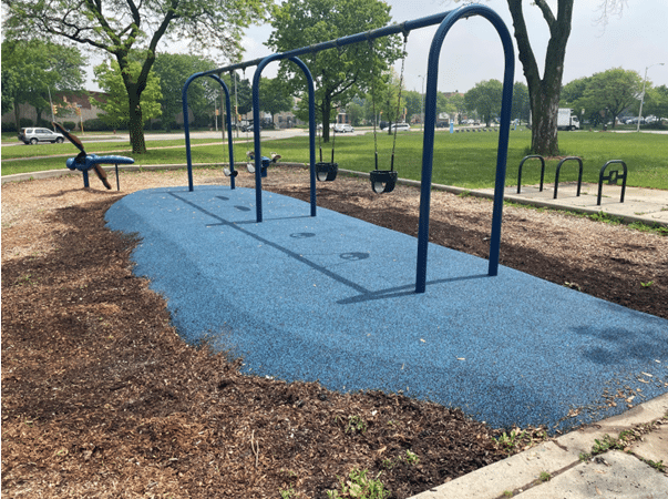 Commercial playground safety surfacing and heavy-duty swing set frames for parks and recreation areas.